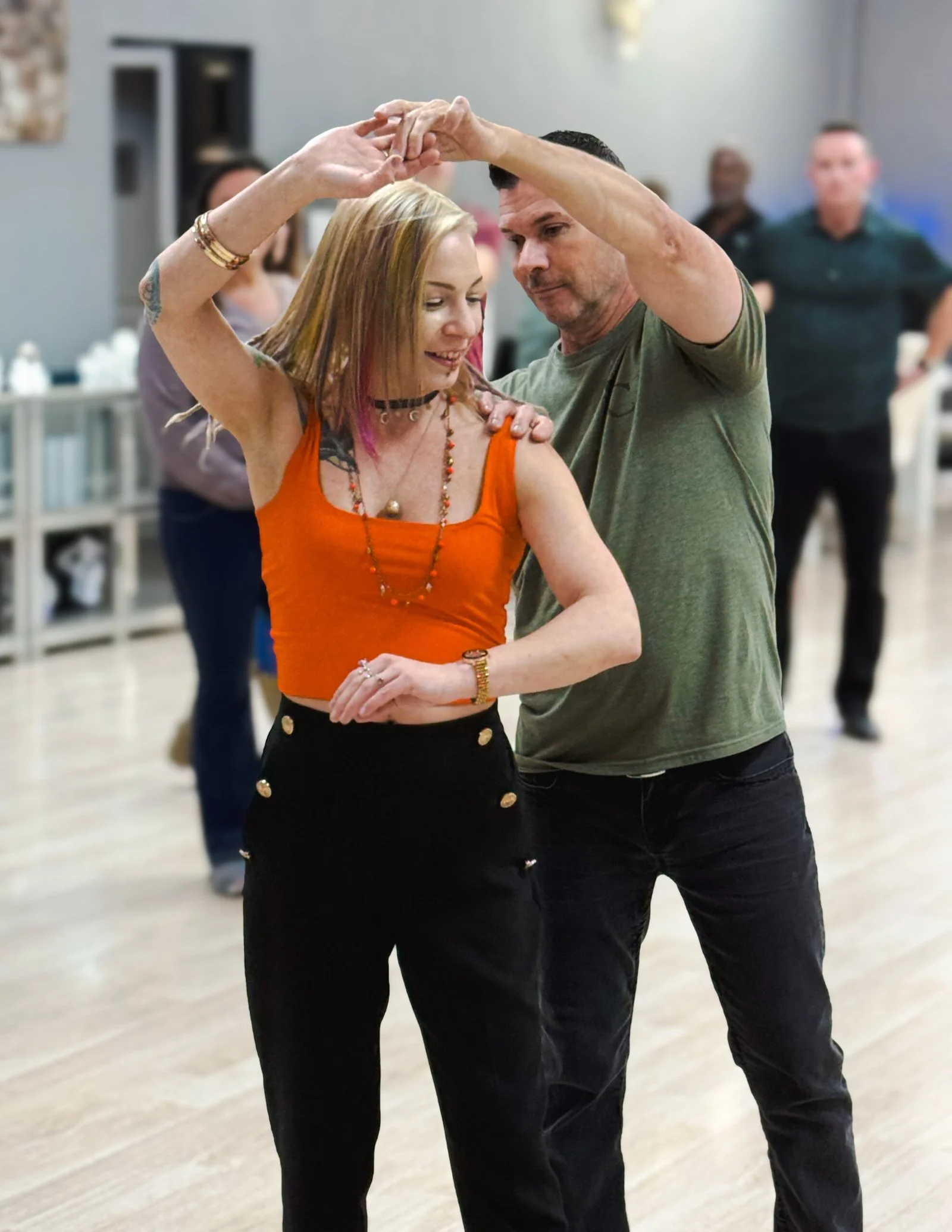 Adults learning beginner partner dancing during Monday dance classes in The Woodlands TX